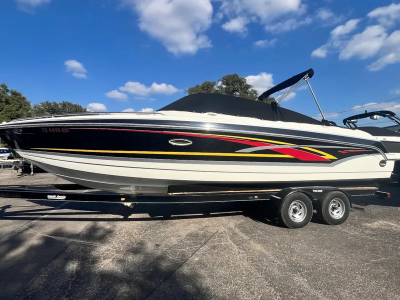 Slide: The Image of 2007 Formula Sun Sport 260 boat with vibrant graphics on a trailer under a blue sky. - 2