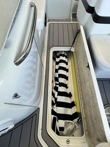 Slide: The Image of Storage compartment on a 2007 Formula Sun Sport 260 boat with striped fabric inside. - 8