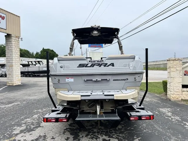 Slide: The Image of 2024 Supra SL 450 boat rear view in dealership parking lot. - 10