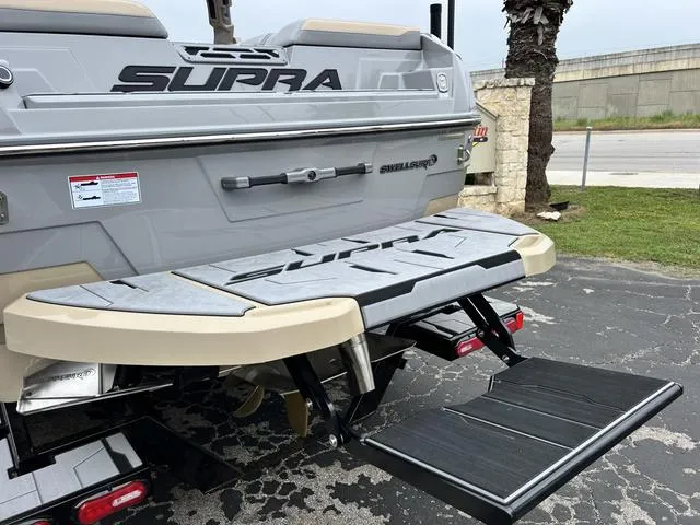 Slide: The Image of 2024 Supra SL 450 boat rear view with swim platform and step ladder. - 11