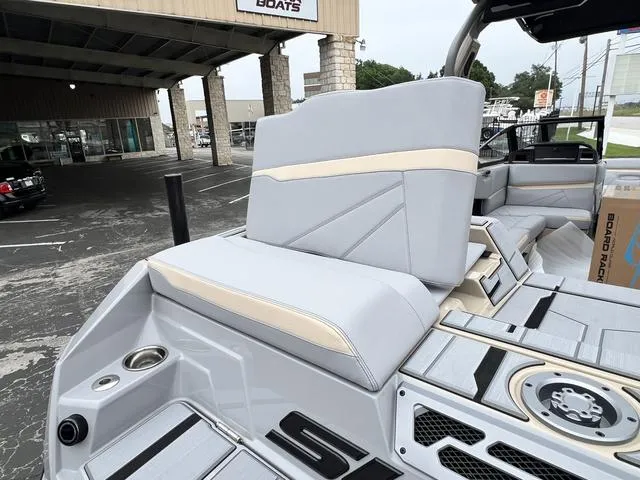 Slide: The Image of 2024 Supra SL 450 boat interior with gray and beige seating. - 18