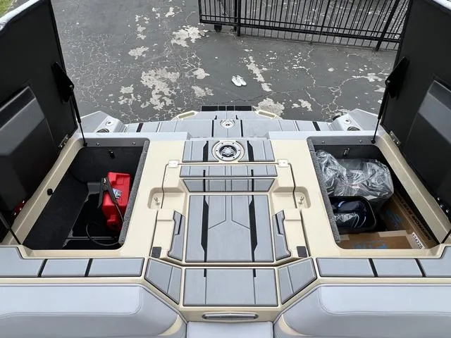 Slide: The Image of 2024 Supra SL 450 boat with open storage compartments on the deck. - 20