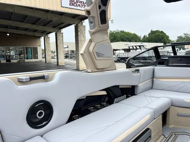Slide: The Image of Interior of a 2024 Supra SL 450 boat with luxurious seating and sound system. - 24