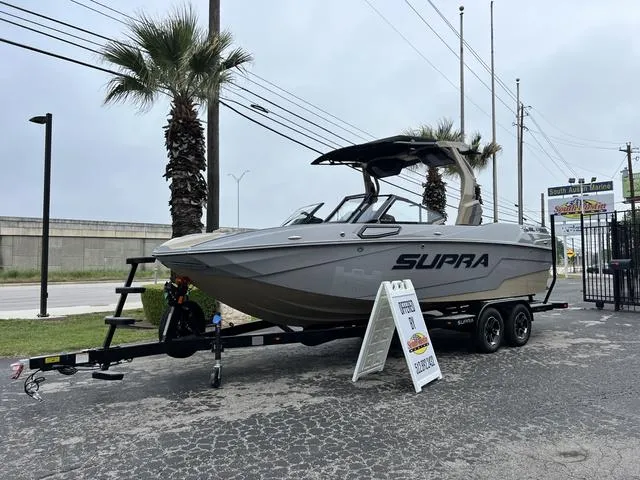 Slide: The Image of 2024 Supra SL 450 boat on trailer, displayed outdoors near palm trees. - 3