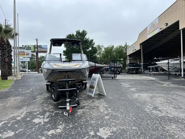 Slide: The Image of 2024 Supra SL 450 boat on trailer at dealership. - 4