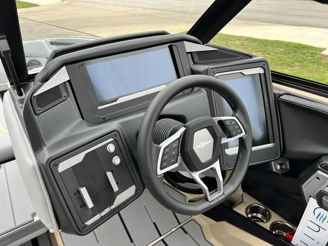Slide: The Image of 2024 Supra SL 450 boat dashboard with advanced touchscreen controls and modern steering wheel. - 44