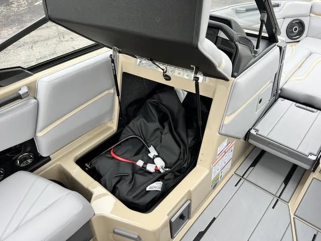 Slide: The Image of 2024 Supra SL 450 boat interior storage compartment with open lid. - 48
