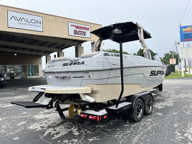 Slide: The Image of 2024 Supra SL 450 boat on trailer at dealership. - 9