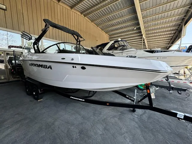 The Image of 2024 Moomba Max boat on trailer in covered storage. - 1