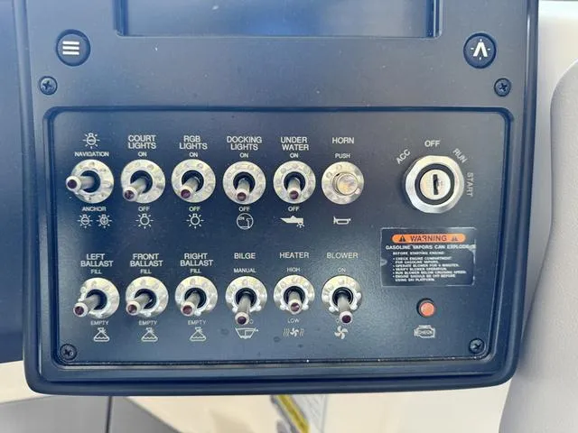 Slide: The Image of Control panel of a 2024 Moomba Max boat with various switches and ignition. - 12