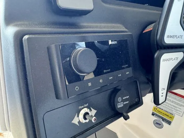 Slide: The Image of 2024 Moomba Max boat dashboard controls and audio system. - 13