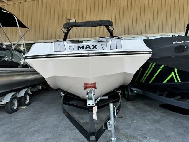 Slide: The Image of 2024 Moomba Max boat on a trailer in a showroom. - 2