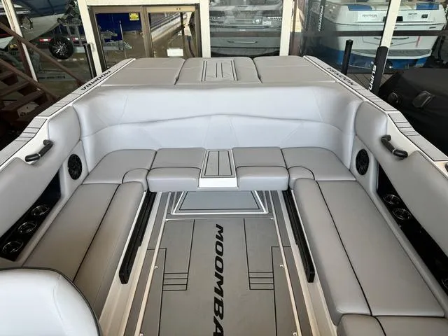 Slide: The Image of 2024 Moomba Max boat interior with gray seating and flooring. - 5