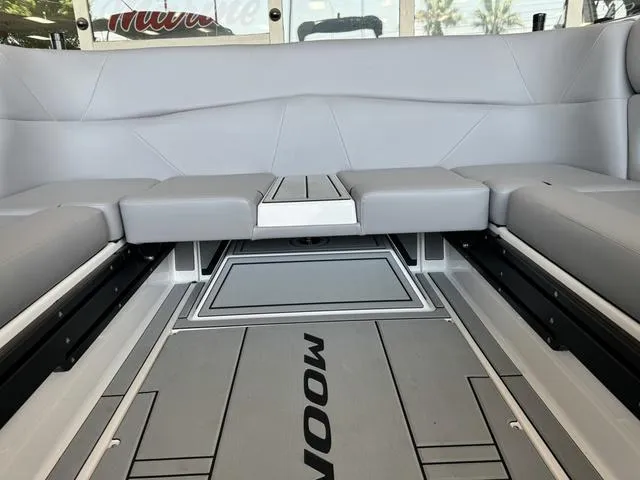 Slide: The Image of 2024 Moomba Max boat interior with gray seating and flooring. - 6