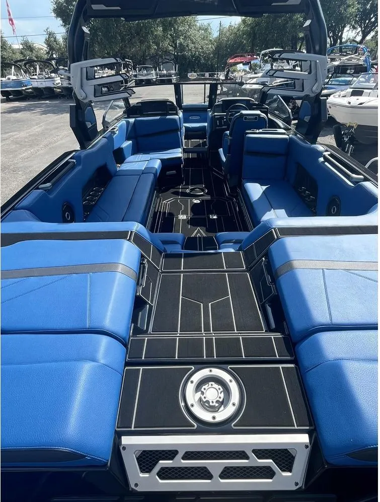 Slide: The Image of 2024 Supra SE 550 boat interior with blue seating and sleek design. - 2
