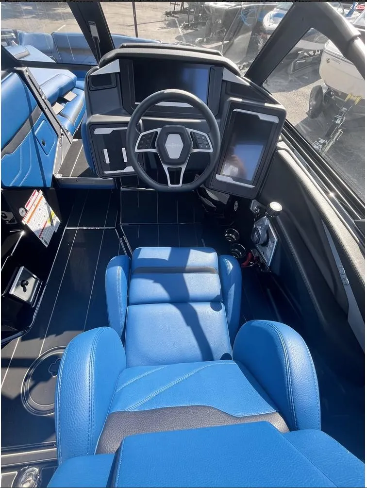 Slide: The Image of 2024 Supra SE 550 boat interior with blue seating and modern dashboard. - 4