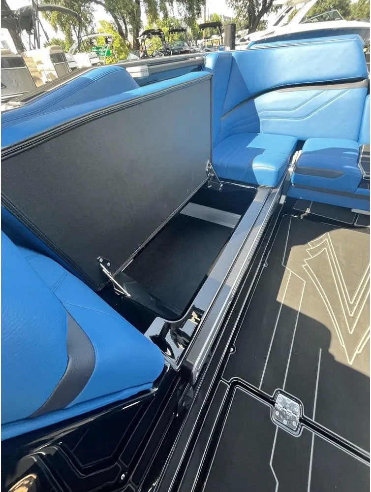 Slide: The Image of 2024 Supra SE 550 boat interior with blue seating and storage compartment. - 7