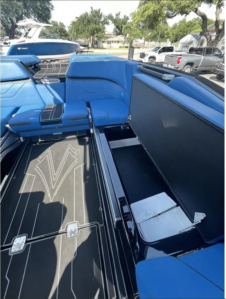 Slide: The Image of 2024 Supra SE 550 boat interior with blue seating and storage compartments. - 8