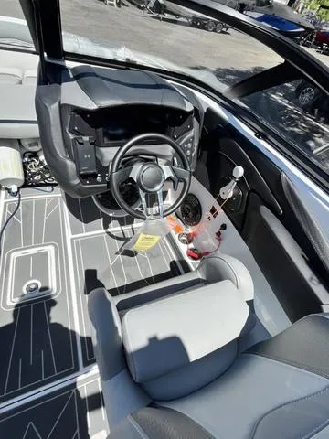 Slide: The Image of 2021 Centurion Fi 23 boat interior, featuring steering wheel and dashboard. - 11