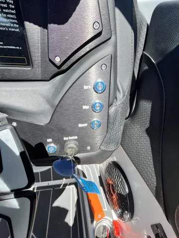 Slide: The Image of Control panel of a 2021 Centurion Fi 23 boat with key ignition and buttons. - 13