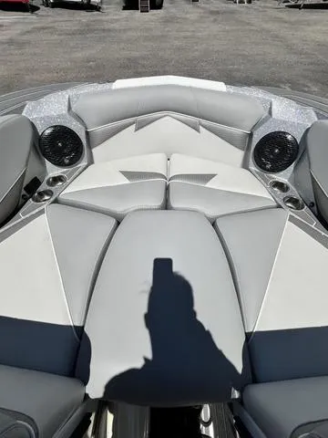 Slide: The Image of 2021 Centurion Fi 23 boat interior with gray and white seating and built-in speakers. - 19