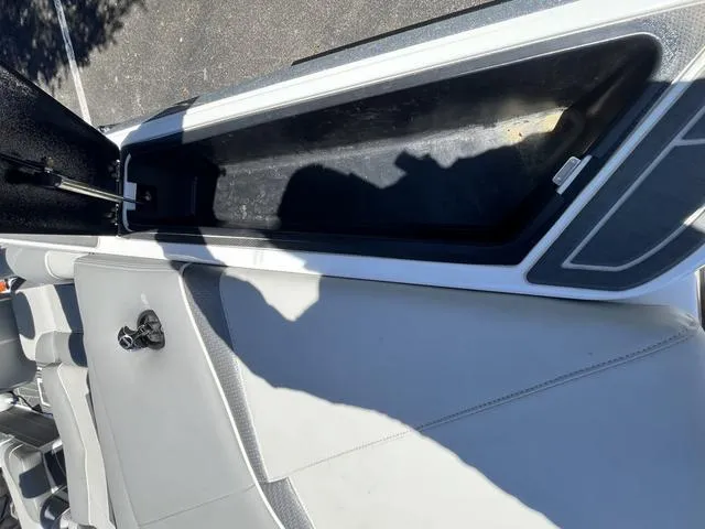 Slide: The Image of Open storage compartment in a 2021 Centurion Fi 23 boat. - 24