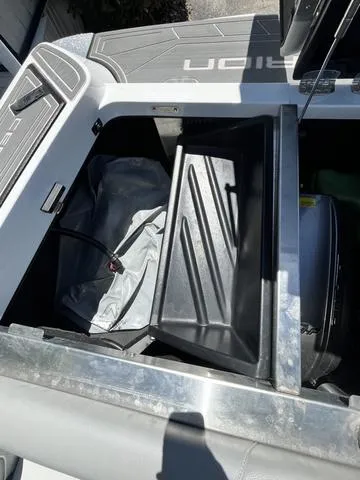 Slide: The Image of 2021 Centurion Fi 23 boat storage compartment with ballast bag and engine. - 6