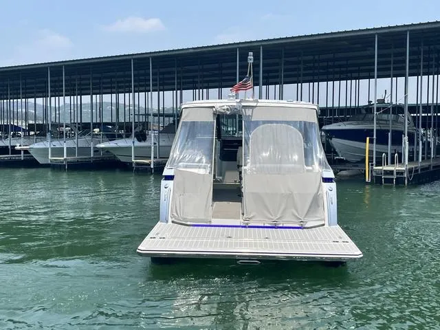 Slide: The Image of 2022 Formula 380 Super Sport Crossover docked at a marina with covered seating area. - 10