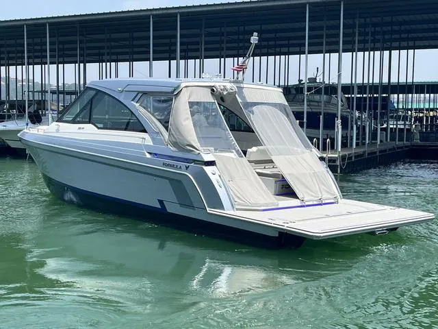 Slide: The Image of 2022 Formula 380 Super Sport Crossover boat docked in a marina. - 11