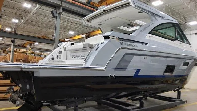 Slide: The Image of 2022 Formula 380 Super Sport Crossover boat in a showroom. - 13