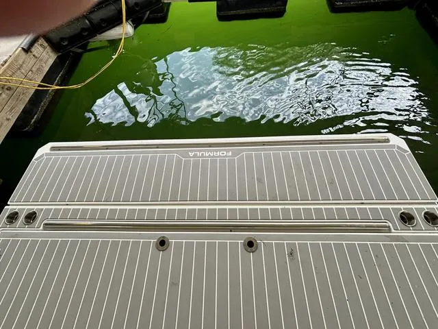 Slide: The Image of 2022 Formula 380 Super Sport Crossover swim platform by the water. - 16