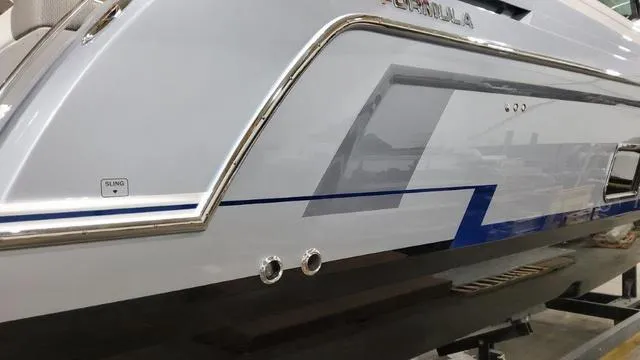 Slide: The Image of 2022 Formula 380 Super Sport Crossover boat side view in a showroom. - 18