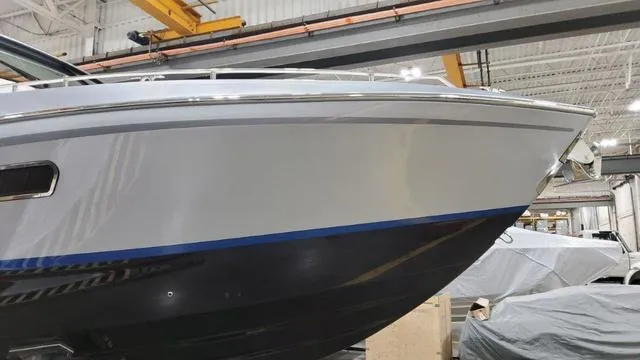 Slide: The Image of 2022 Formula 380 Super Sport Crossover boat in a warehouse setting. - 23