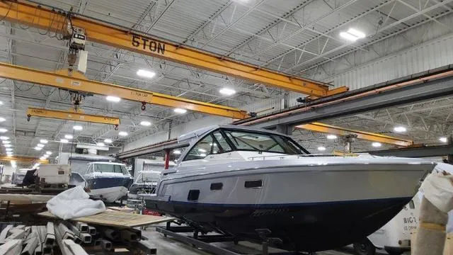 Slide: The Image of 2022 Formula 380 Super Sport Crossover boat in a manufacturing facility. - 25