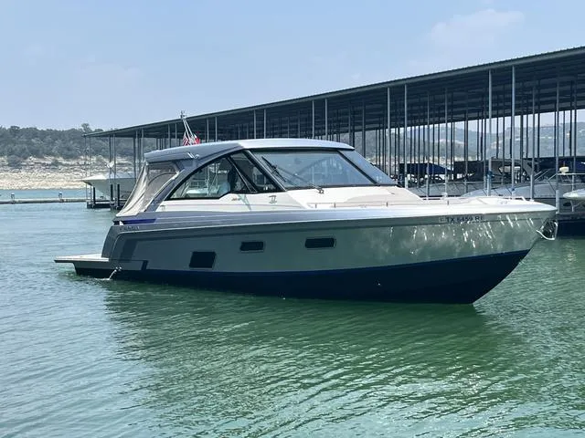 Slide: The Image of 2022 Formula 380 Super Sport Crossover boat docked on calm water. - 3