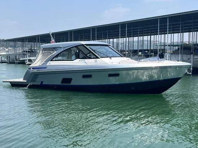 Slide: The Image of 2022 Formula 380 Super Sport Crossover boat docked in a marina. - 4
