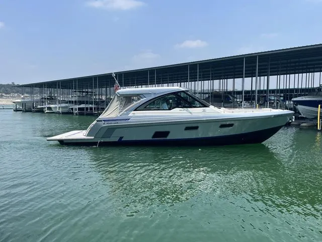Slide: The Image of 2022 Formula 380 Super Sport Crossover boat docked in marina. - 5