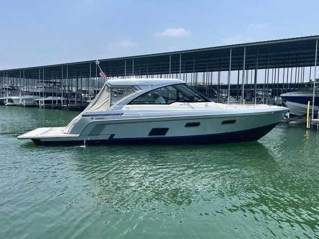 Slide: The Image of 2022 Formula 380 Super Sport Crossover boat docked in marina. - 6
