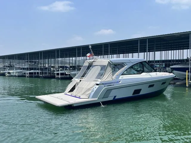 Slide: The Image of 2022 Formula 380 Super Sport Crossover boat docked at a marina. - 8