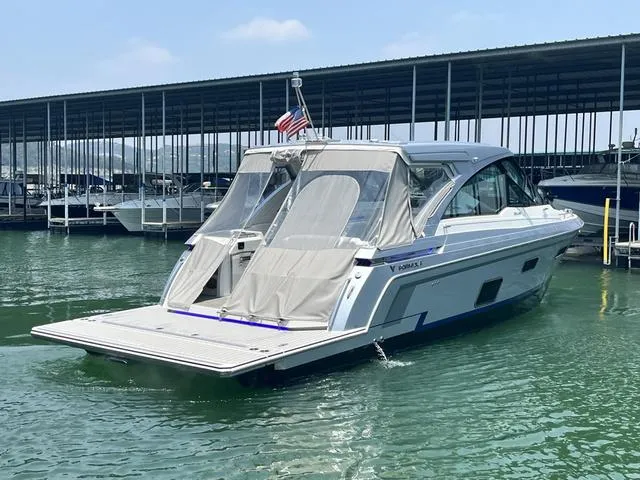 Slide: The Image of 2022 Formula 380 Super Sport Crossover boat docked in marina. - 9