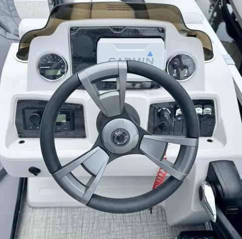Slide: The Image of 2024 Avalon VLS 21 Quad Lounger dashboard with steering wheel and Garmin display. - 5