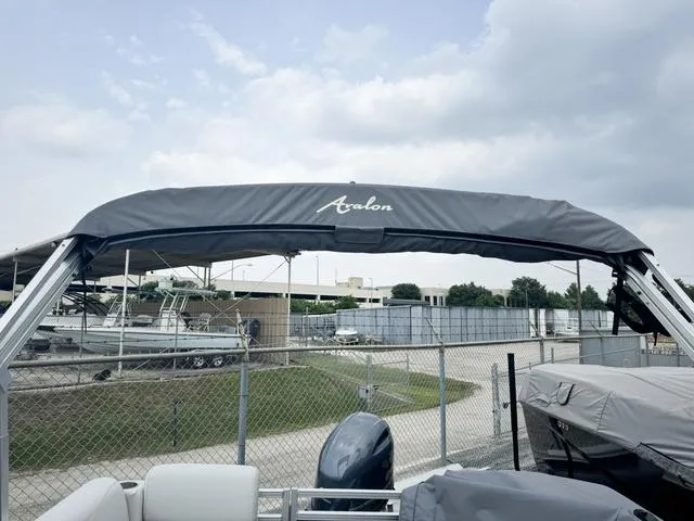 Slide: The Image of 2024 Avalon VLS 21 Quad Lounger pontoon boat with canopy in a marina. - 9