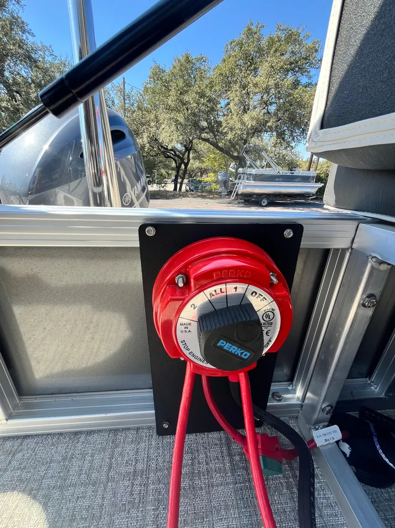 Slide: The Image of 2024 Avalon LSZ Versatile Rear Bench boat battery switch with red cables. - 10