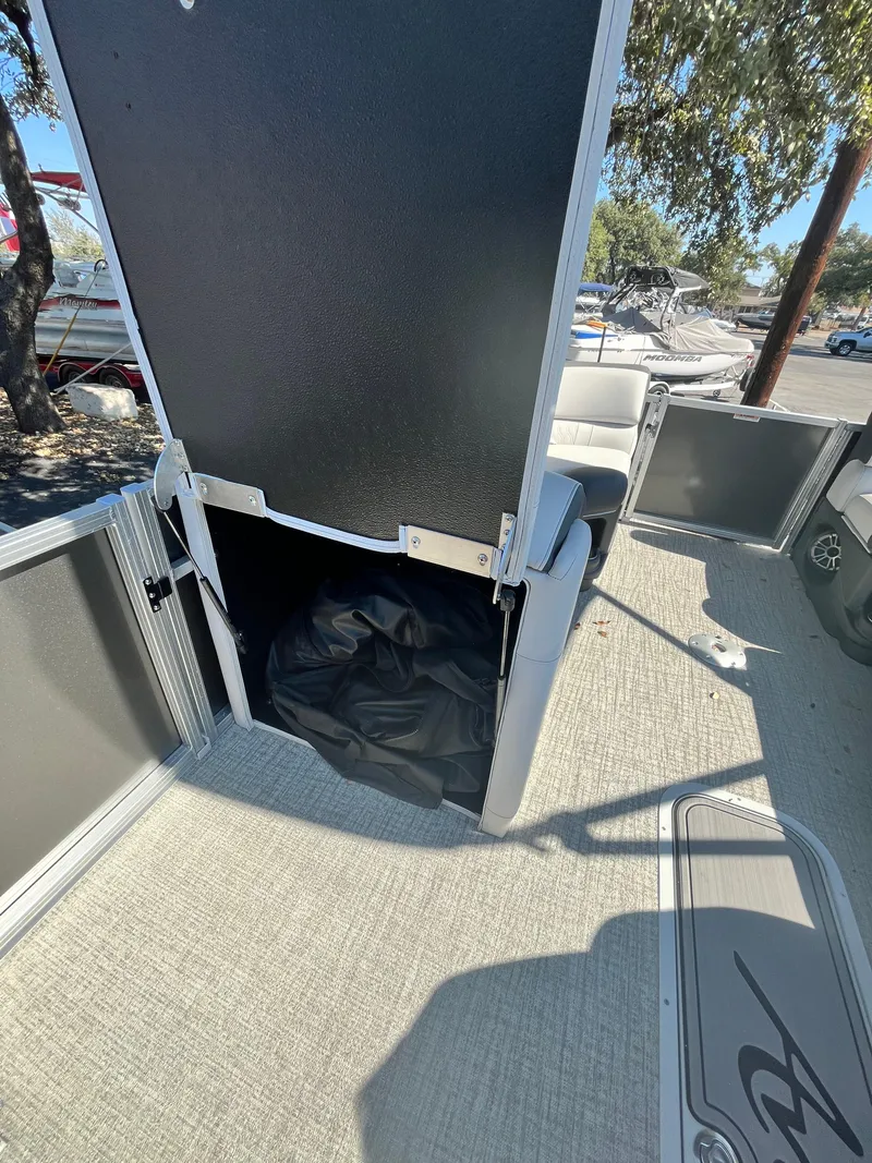 Slide: The Image of 2024 Avalon LSZ Versatile Rear Bench storage compartment on a boat deck. - 12