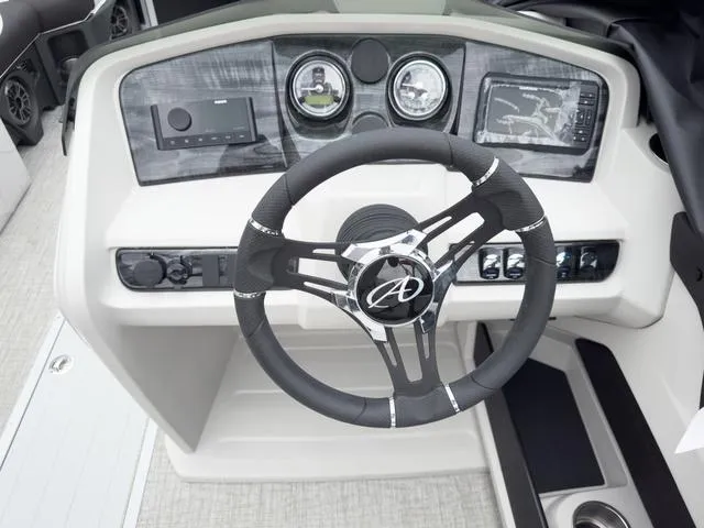 Slide: The Image of 2024 Avalon LSZ 2385 Versatile Rear Bench boat dashboard with steering wheel and control panel. - 6