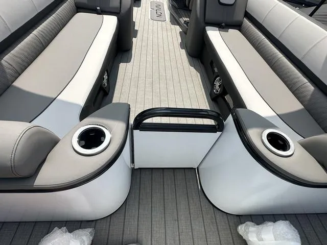 Slide: The Image of 2024 Avalon Catalina 25' Quad Lounger interior with gray seating and cup holders. - 11