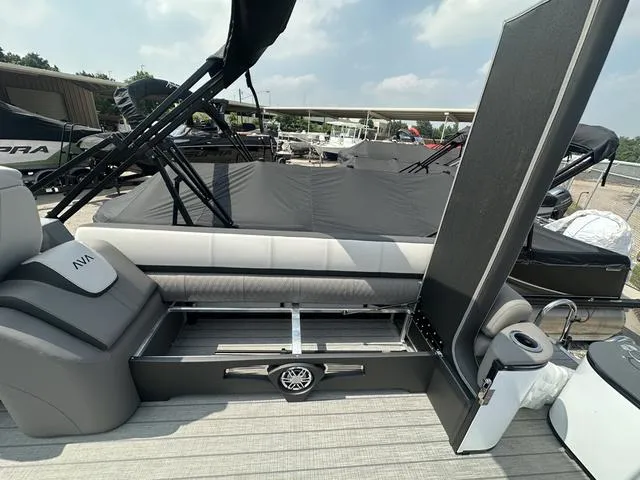 Slide: The Image of 2024 Avalon Catalina 25' Quad Lounger boat interior with storage compartment open. - 15