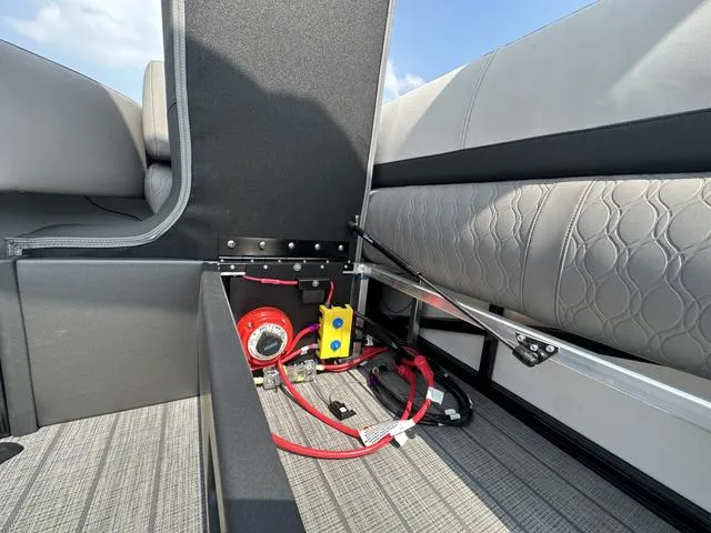 Slide: The Image of 2024 Avalon Catalina 25' Quad Lounger storage compartment with electrical components. - 20