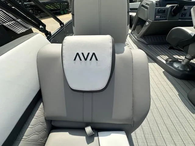 Slide: The Image of 2024 Avalon Catalina 25' Quad Lounger boat interior with gray seating and AVA logo. - 22