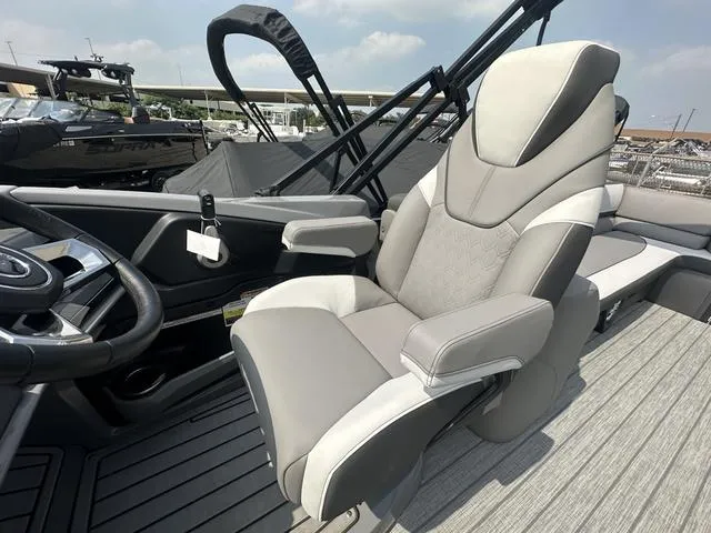 Slide: The Image of 2024 Avalon Catalina 25' Quad Lounger boat interior with luxurious captain's chair. - 25